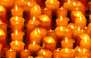 A large group of golden lit candles.